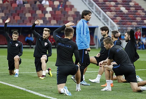Croatia head coach Zlatko Dalic walks amidst his players as they stretch during a training session at Luzhniki Stadium on the eve of the semifinal match between Croatia and England at the 2018 soccer World Cup in Moscow, Russia, Tuesday, July 10, 2018. |