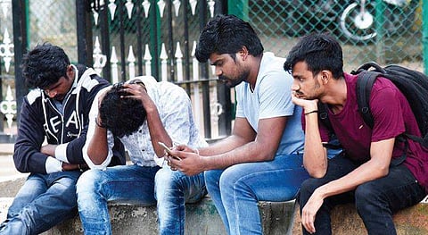 Sharavan’s colleagues wait outside the Victoria Hospital mortuary. (Photo | Vinod Kumar T/EPS)