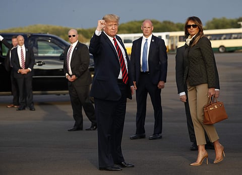 President Donald Trump and first lady Melania Trump look at the media during their arrival on Air Force One at Glasgow Prestwick Airport in Scotland, Friday, July 13, 2018. | AP