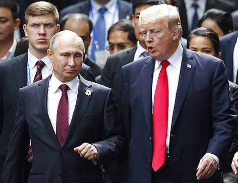 U.S. President Donald Trump and Russia's President Vladimir Putin talk during the family photo session at the APEC Summit in Danang, Vietnam. ( File | AP)