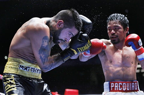 Lucas Matthysse of Argentina, left, shields himself from Manny Pacquiao of the Philippines, during their WBA World welterweight title bout in Kuala Lumpur, Malaysia. | AP