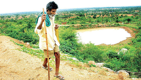 Kamegowda has built 14 ponds on the barren Kundinibetta hill in Malavalli taluk of Mandya district. (Photo | Pandarinath B/EPS)