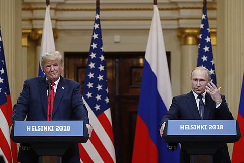 U.S. President Donald Trump, left, listens to Russian President Vladimir Putin during a press conference after their meeting at the Presidential Palace in Helsinki, Finland. (Photo | AP)