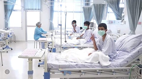 Three of the 12 boys are seen recovering in their hospital beds after being rescued along with their coach from a flooded cave in Mae Sai, Chiang Rai province. ( Photo | AP)