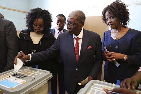 Former Zimbabwean Leader President Robert Mugabe prepares to cast his vote at a polling station in Harare. (Photo | AP)