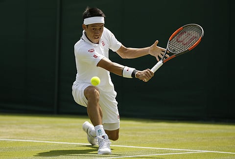 Kei Nishikori of Japan returns the ball to Christian Harrison of the US during their men's singles match on the second day at the Wimbledon Tennis Championships in London, Tuesday July 3, 2018. | AP