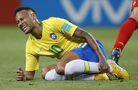 Brazil's Neymar holds his shinbone during the quarterfinal match between Brazil and Belgium at the 2018 soccer World Cup in the Kazan Arena, in Kazan, Russia. | AP