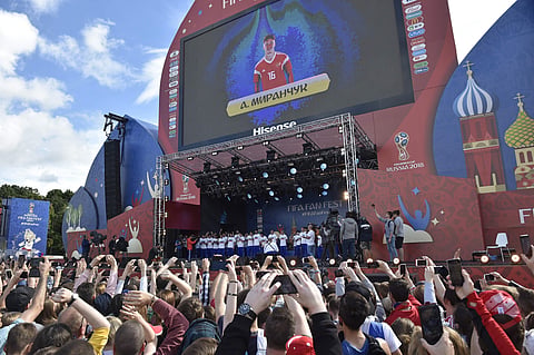 Members of the Russian national football team are greeted by supporters at the fan zone in Moscow during the FIFA World Cup. (AP)