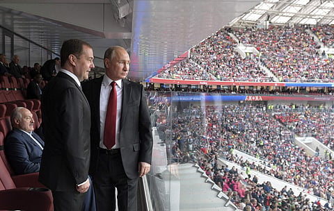 Russian President Vladimir Putin (R) and Russian Prime Minister Dmitry Medvedev look at the field during the opening match of FIFA World Cup 2018 between Russia and Saudi Arabia. (File photo | AP)