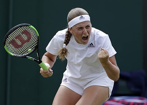 Jelena Ostapenko of Latvia celebrates winning a game from Aliaksandra Sasnovich of Belarus during their women's singles match on the seventh day at the Wimbledon Tennis Championships in London. (AP)