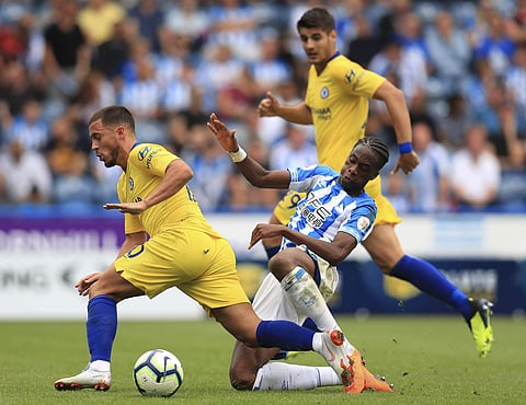 Chelsea's Eden Hazard, left, and Huddersfield Town's Terence Kongolo during their English Premier League soccer match at the John Smith's Stadium in Huddersfield, England, Saturday Aug. 11, 2018. | AP
