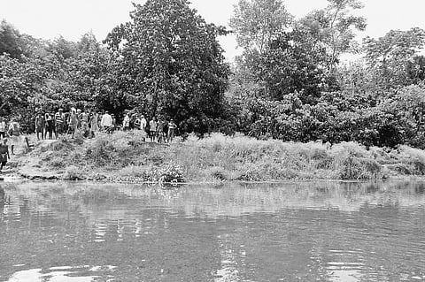 Villagers check an embankment after a downpour | EXPRESS