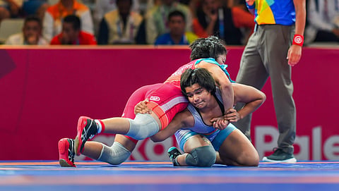 India's Divya Kakran blue during her 68 kg freestyle wrestling match against Mongolia s Tumentsetseg Sharkhuu at the Asian Games 2018 in Jakarta on Tuesday. (Photo | PTI)