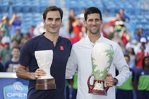 Novak Djokovic, right, of Serbia, holds the Rookwood Cup after defeating Roger Federer, left, of Switzerland, during the finals at the Western & Southern Open tennis tournament, Sunday, Aug. 19, 2018, in Mason, Ohio. | AP