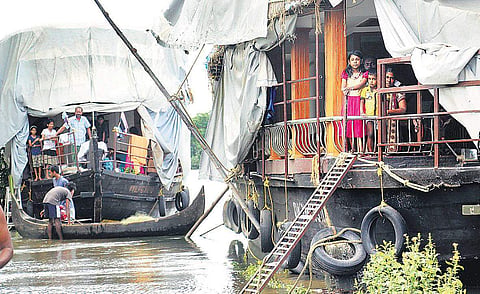 The families at Cheepungal near Kumarakom, who shifted to houseboats after their houses were inundated | Vishnu Prathap