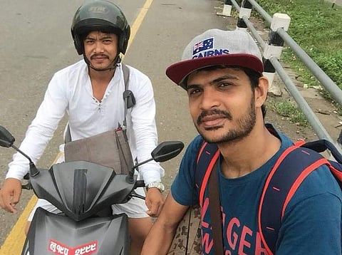 Shakir Subhan posing with a two-wheeler rider at Kathmandu in Nepal after ending his 7-day hitchhiking trip