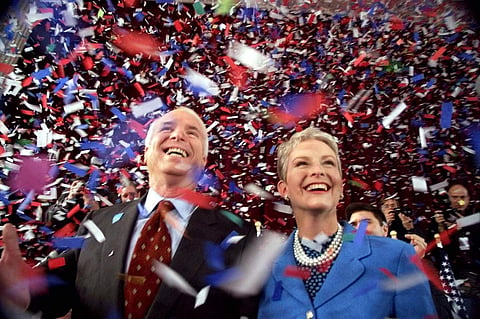 Confetti falls on Republican presidential hopeful Sen. John McCain, R-Ariz., and his wife, Cindy, at the end of their 114th New Hampshire town hall meeting with voters at the Peterborough Town House in Peterborough, N.H. (Photo | AP)