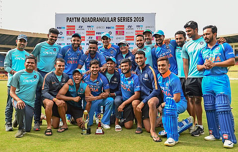 India B players pose with the trophy after winning against Australia A during the Quadrangular 'A' series final match at Chinnaswamy Stadium | PTI