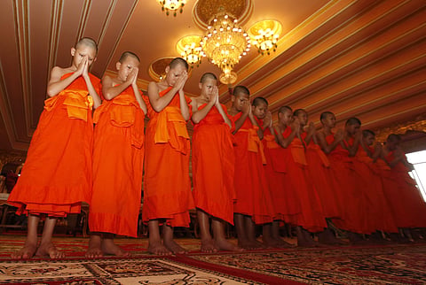Members of Wild Boars soccer team pray during a ceremony marking the completion of their serving as novice Buddhist monks, following their dramatic rescue from a cave in Mae Sai district. (Photo | AP)