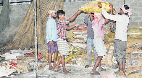 Workers clear out rotten rice from Ameen Traders at Thottumukkam | A Sanesh
