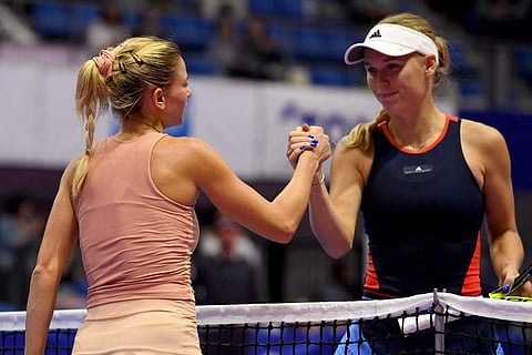 Camila Giorgi of Italy (L) is congraturated by Caroline Wozniacki of Denmark after winning their women's singles second round tennis match at the Pan Pacific Open tennis tournament in Tokyo on September 20, 2018. | AFP