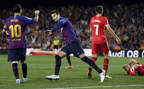 FC Barcelona's Gerard Pique celebrates with his teammate Lionel Messi after scoring during the Spanish La Liga match against Girona | AP