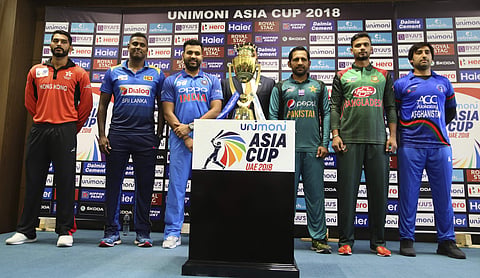 Captains of six cricket teams participating in Asia Cup, from left, Hong Kong's Anshy Rath, Sri Lanka's Angelo Mathews, India's Rohit Sharma, Pakistan's Sarfraz Ahmed, Bangladesh's Mashrafe Mortaza and Afghanistan's Asghar Afghan pose with the winners tro