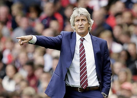 West Ham manager Manuel Pellegrini gives instructions during the English Premier League soccer match between Arsenal and West Ham United at the Emirates Stadium in London, Saturday Aug. 25, 2018. | AP
