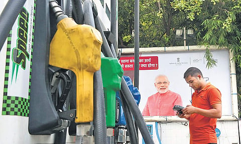 A customer makes payment at a petrol pump in New Delhi on Saturday. Petrol price reached B80.44 per litre in the National Capital | SHEKHAR YADAV