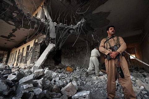Members of the Iranian Kurdistan Democratic Party check the damage after a rocket attack inside their headquarters in Koysinjaq, 100 kilometres east of Arbil, the capital of the autonomous Kurdish region of northern Iraq. (Photo | AFP)