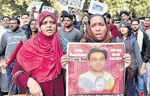 Najeeb Ahmed’s mother, Fatima Nafees ( right) participates in a protest march demanding a proper investigation into the missing case of his son.