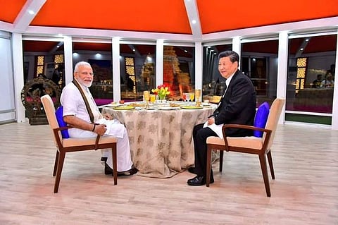 PM Modi and Chinese President Xi Jinping having a conversation over dinner at Mahabalipuram during the informal summit. (Photo | Twitter)