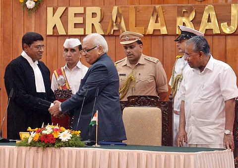 Kerala Governor Arif Mohammed Khan greets Justice S Manikumar who was sworn in as the 36th Chief Justice of Kerala High Court. Chief Minister Pinarayi Vijayan looks on during the swearing-in ceremony held at the Raj Bhavan in Thiruvananthapuram on Friday