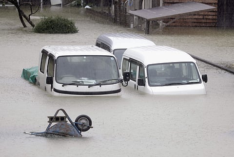 Cars sit submerged in water in the residential area hit by Typhoon Hagibis, in Ise, central Japan . (Photo | AP)