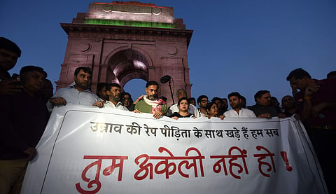 People assemble to send across a message of solidarity to the Unnao rape survivor at India Gate in New Delhi, January, 2024.