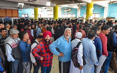 People stand in a queue at a telecom office to restore their mobile phones in Srinagar Monday Oct. 14 2019. | (Photo | PTI)