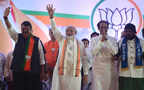 Prime minister Narendra Modi along with Maharashtra CM Devendra Fadnavis Shiv Sena president Uddhhav Thackeray and RPI leader Ramdas Athawale waves during an election rally ahead of Maharashtra Assembly elections in Mumbai Friday Oct. 18 2019. | (Photo |
