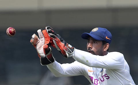 India's Wriddhiman Saha prepares to catch the ball during a training session. (Photo | AP)