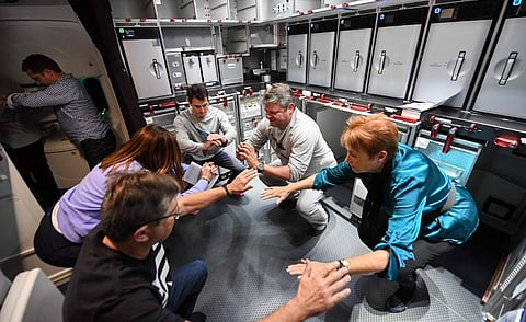In this handout photo from Qantas taken on on October 19, 2019 shows passangers and crew exercising on a Qantas Boeing 787 Dreamliner plane during a non-stop test flight from New York to Sydney. (Photo | AFP/Qantas)