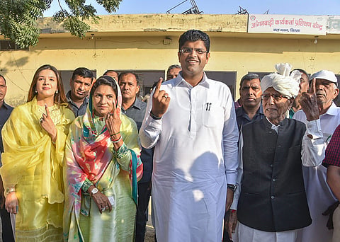 Dushyant Chautala, his wife Meghna Chautala and others show their fingers marked with indelible ink after casting their votes. (Photo | PTI)