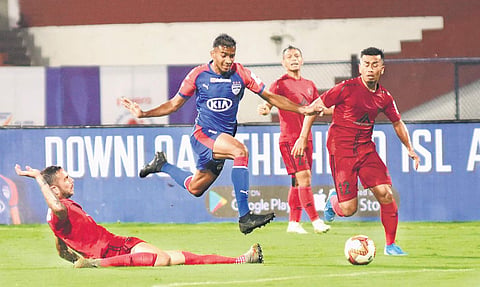 BFC’s Ashique Kuruniyan & Reagan Singh (R) of NEUFC vie for the ball during their ISL match at the Sree Kanteerava Stadium, in Bengaluru on Monday | vinod kumar t