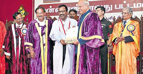 Actor Charle receiving his doctorate from Governor Banwarilal Purohit. Also seen is Minister for Tamil Official Language and Tamil Culture K Pandiarajan | Express