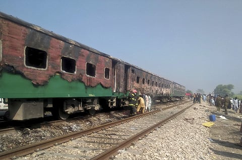 Pakistani officials examine a train damaged by a fire in Liaquatpur, Pakistan, Thursday, Oct. 31, 2019. A massive fire engulfed three carriages of the train traveling in the country's eastern Punjab province. (Photo | AP)