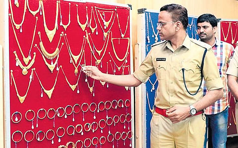 SP S Senthil Kumar examining the gold ornaments recovered in Andhra Bank theft case in Chittoor on Wednesday | express