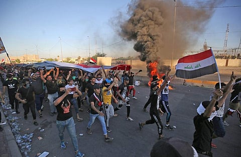 Iraqi protesters take part in a demonstration against state corruption, failing public services, and unemployment, in the Iraqi capital Baghdad. (Photo | AFP)
