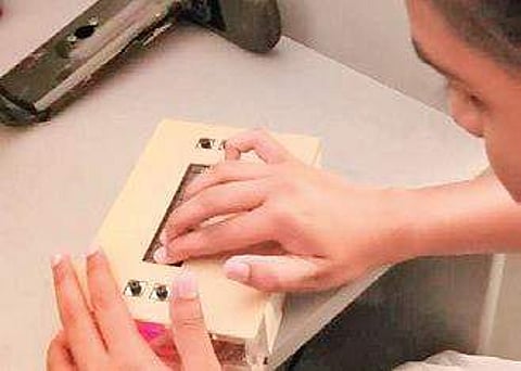 A student at Shree Ramana Maharishi Academy for the Blind using the device