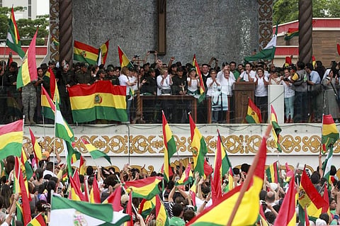 People accompanied by police celebrate the resignation of Bolivian President Evo Morales in Santa Cruz. (Photo | AFP)