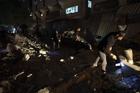 Palestinians check the damage of a house targeted by Israeli missile strikes in Gaza City, Tuesday, Nov. 12, 2019. The Israeli military says it has struck a Gaza City house, targeting a commander from the Islamic Jihad group in a resumption of pinpointed