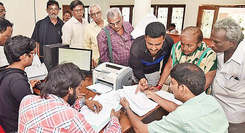 People standing in queue to submit applications at SIT office at Yeleru Guest House in the city on Monday| Express