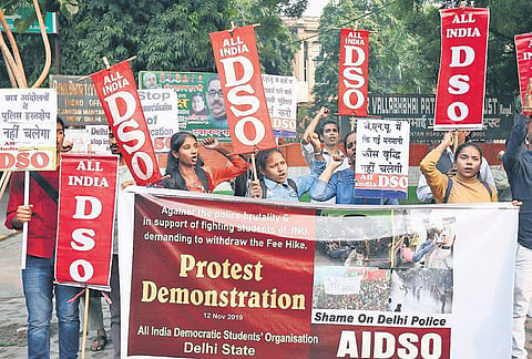 Members of All India Democratic Students’ Organisation shout slogans as they protest the Delhi Police action against the agitating Jawaharlal Nehru University students, in New Delhi on Tuesday; (